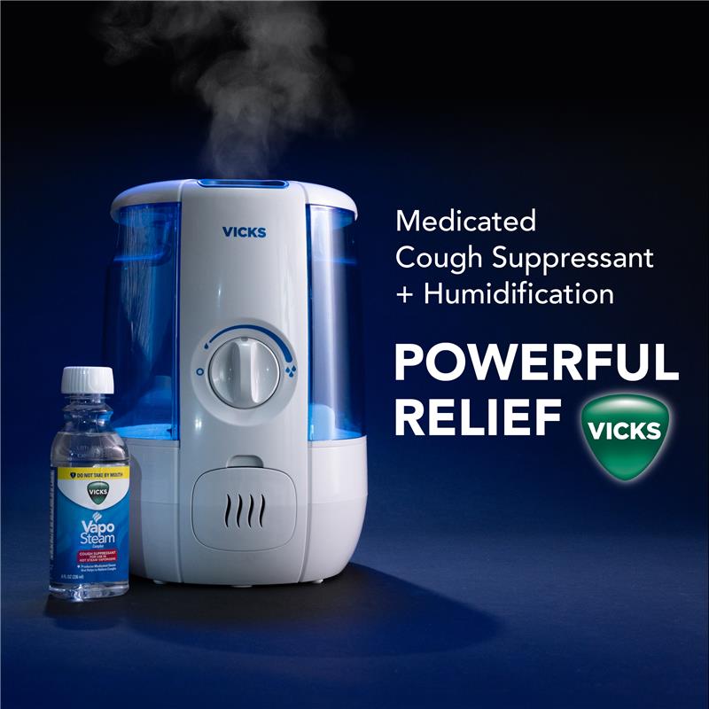 Vicks Cool Mist humidifier device releasing soothing vapors, placed next to Vicks Vaposteam bottle on a dark blue background with text Medicated Cough Suppressant plus humidification equals to powerful relief and Vicks logo