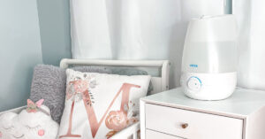 Vicks Cool Mist Humidifier on a bed stand next to a bed