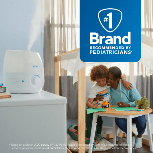 A parent and a child in a room with a Vicks Cool Mist Mini Humidifier. A #1 brand recommended by pediatricians.